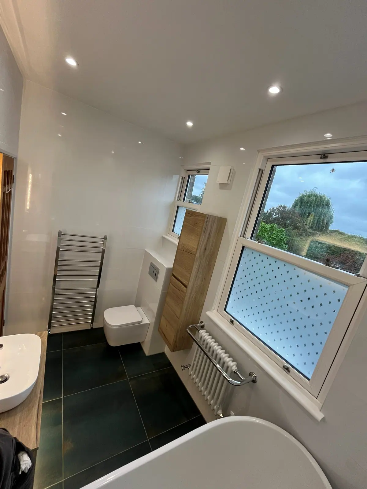 The bathroom from the far end, with the wall-hung toilet and towel radiator