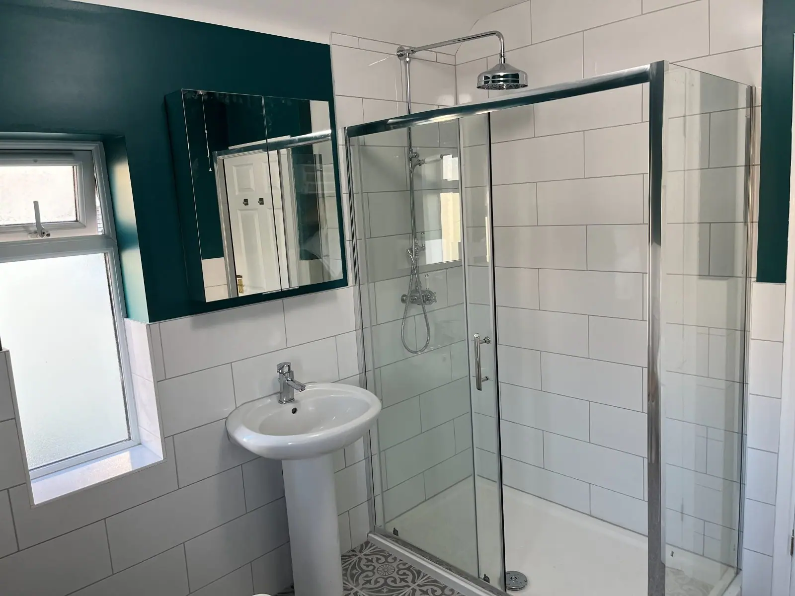 The separate shower enclosure and pedestal basin