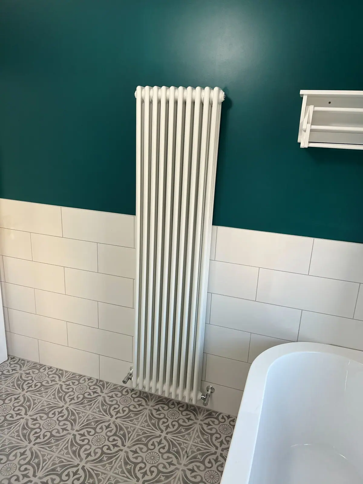 The tall column radiator against the painted wall
