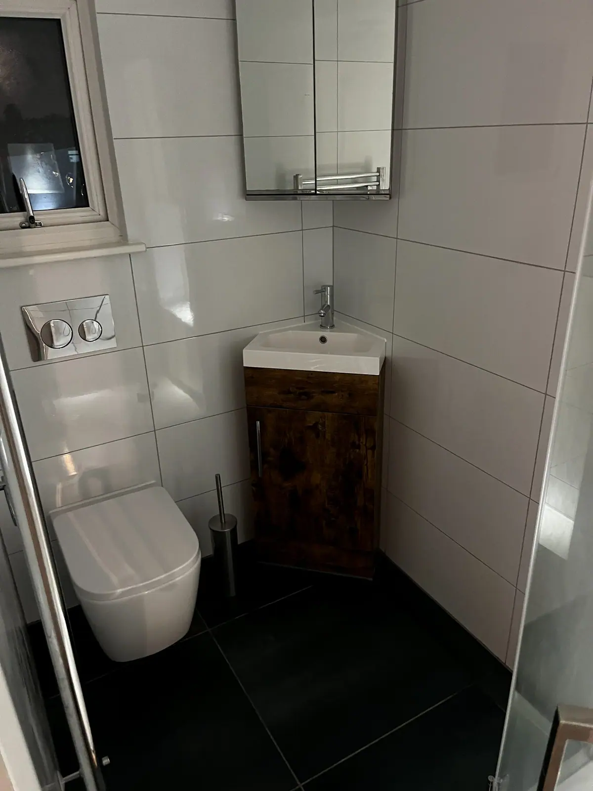 The wall-hung toilet and corner vanity basin