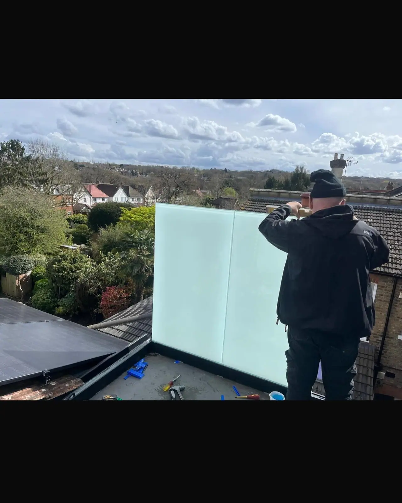 Before: glass balustrade panels being set out on the roof terrace