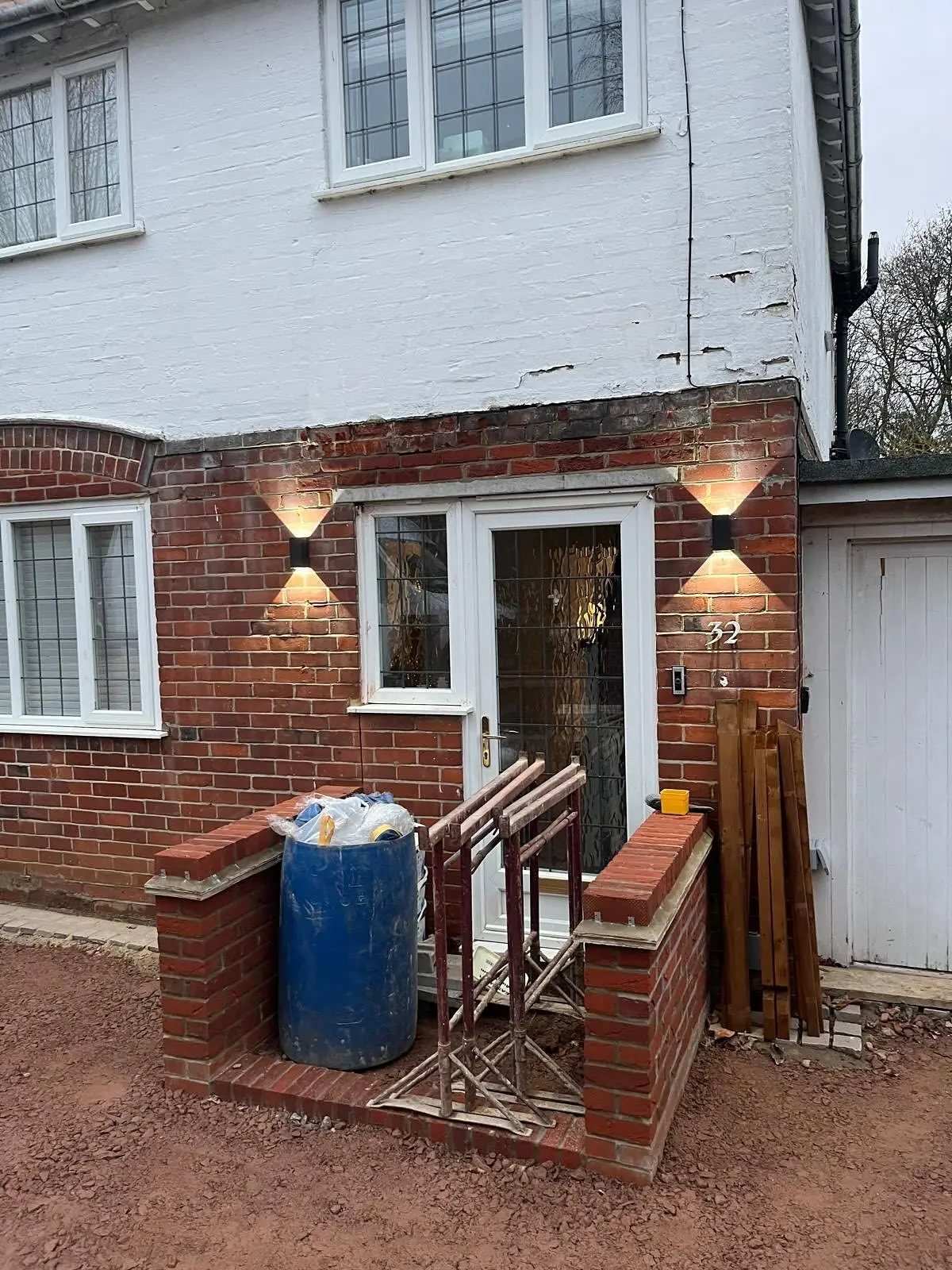 Before: the front of the house with new brick piers built either side of the door