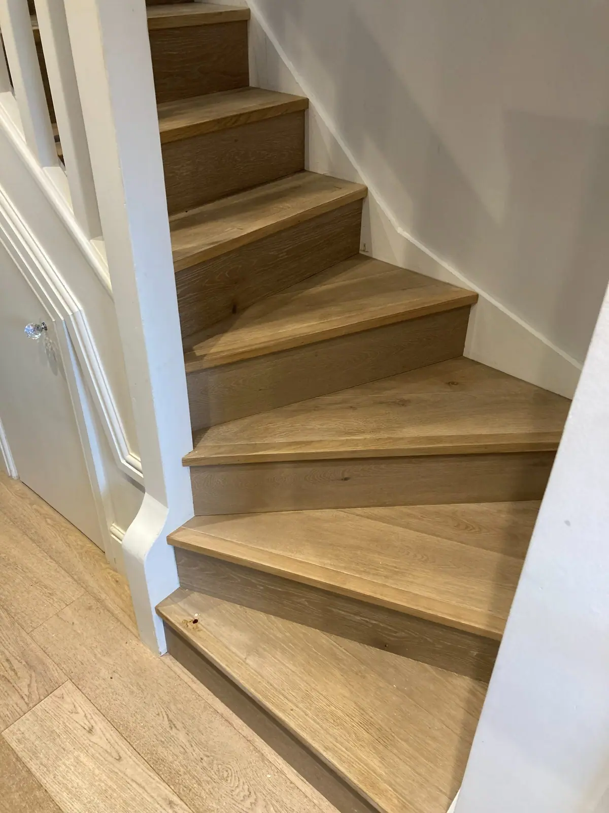 A winding staircase clad in oak-effect treads and risers