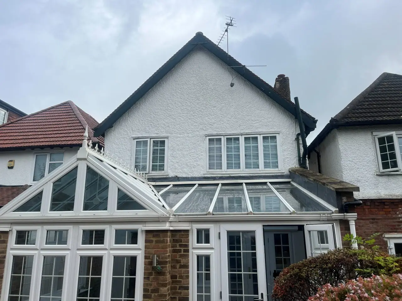 Rendered gable and conservatory before the roof was replaced