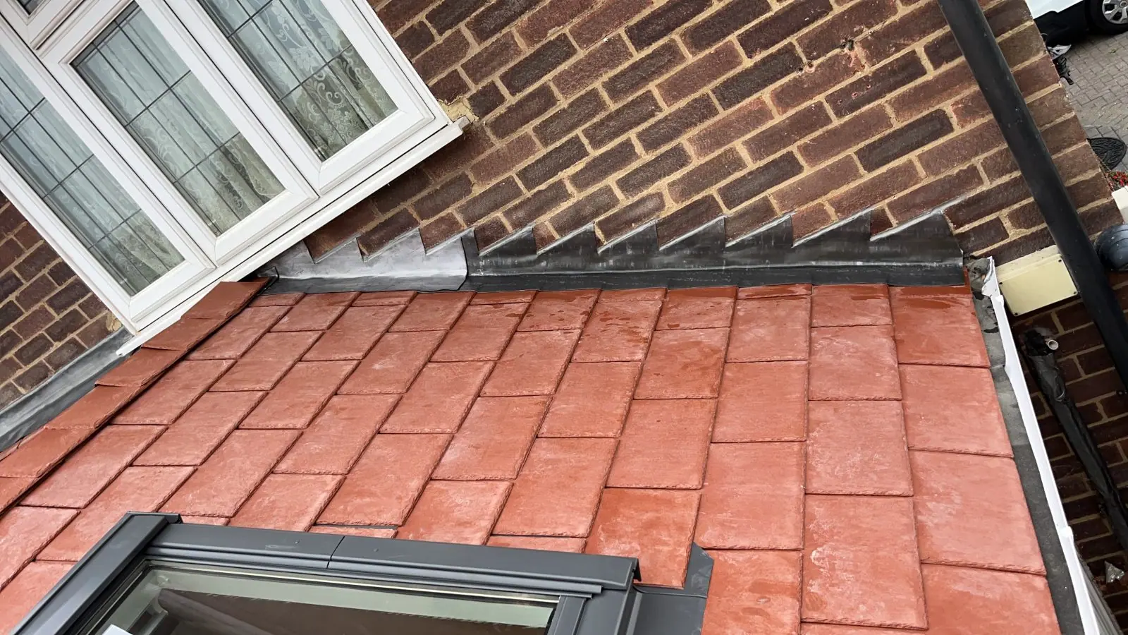 Close view of the tile courses and the roof window flashing