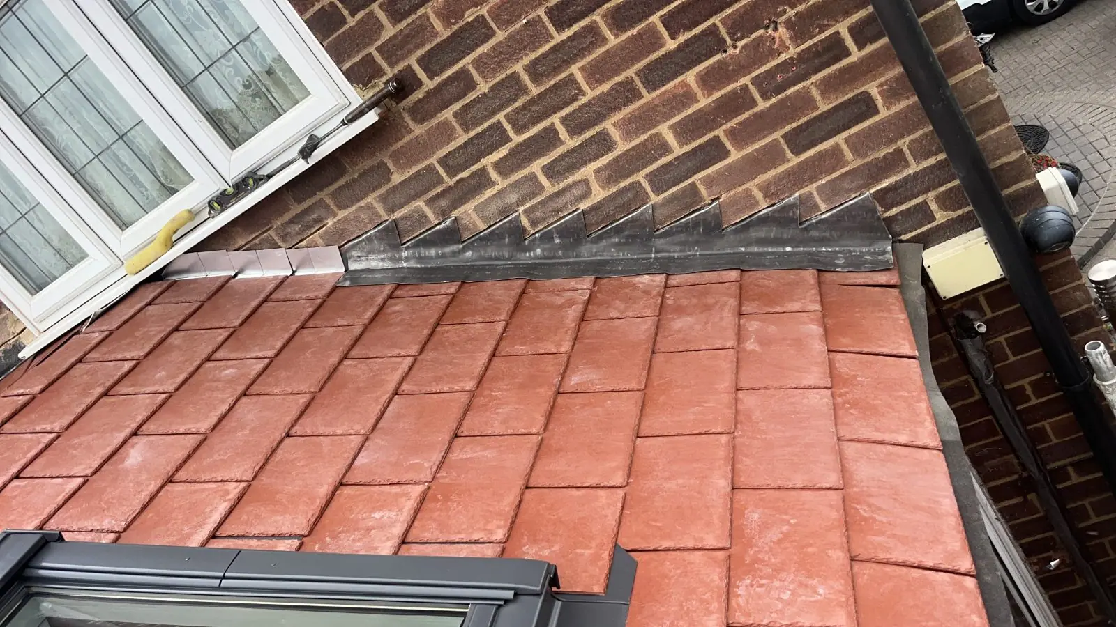 Close view of the tiles meeting the house wall