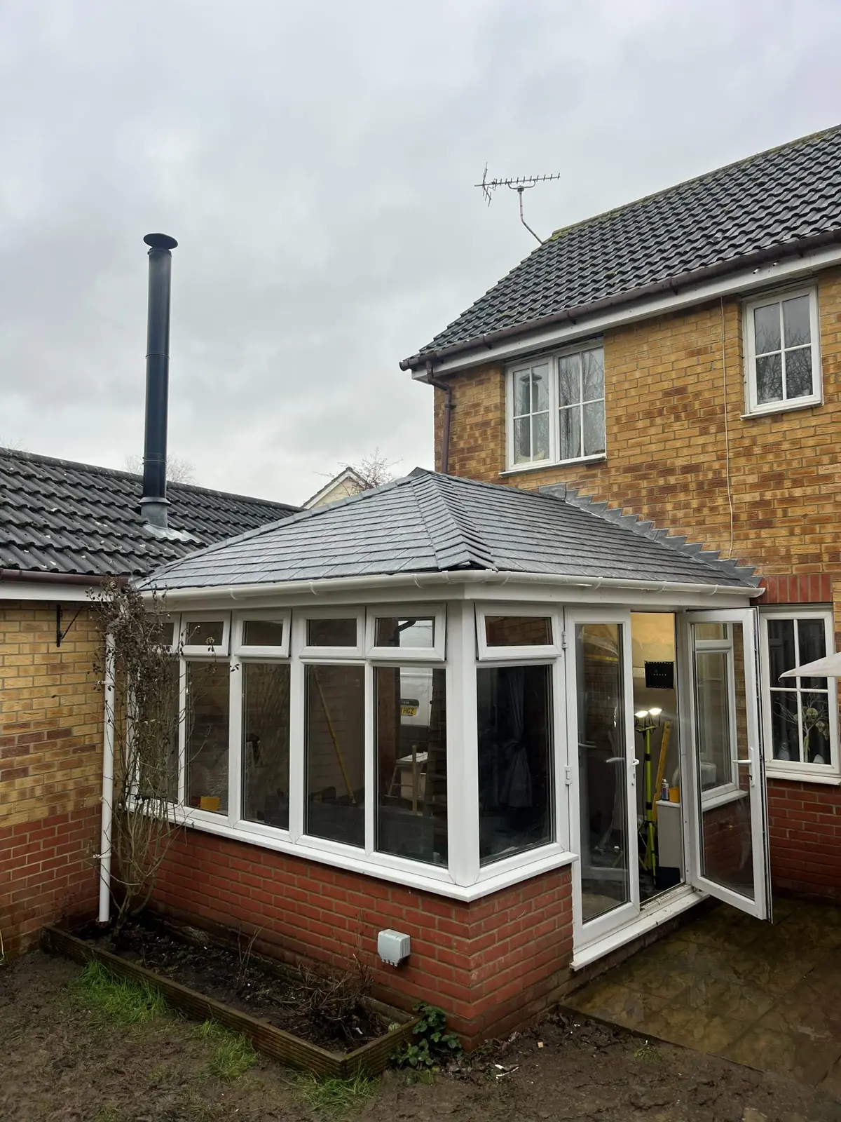 The finished conservatory from the far side of the garden