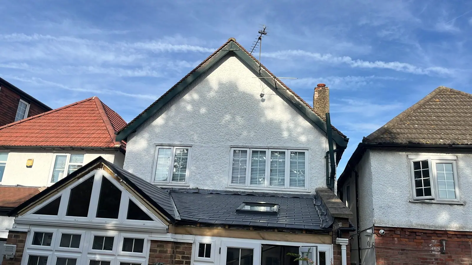 The rendered gable and the new slate-grey conservatory roof