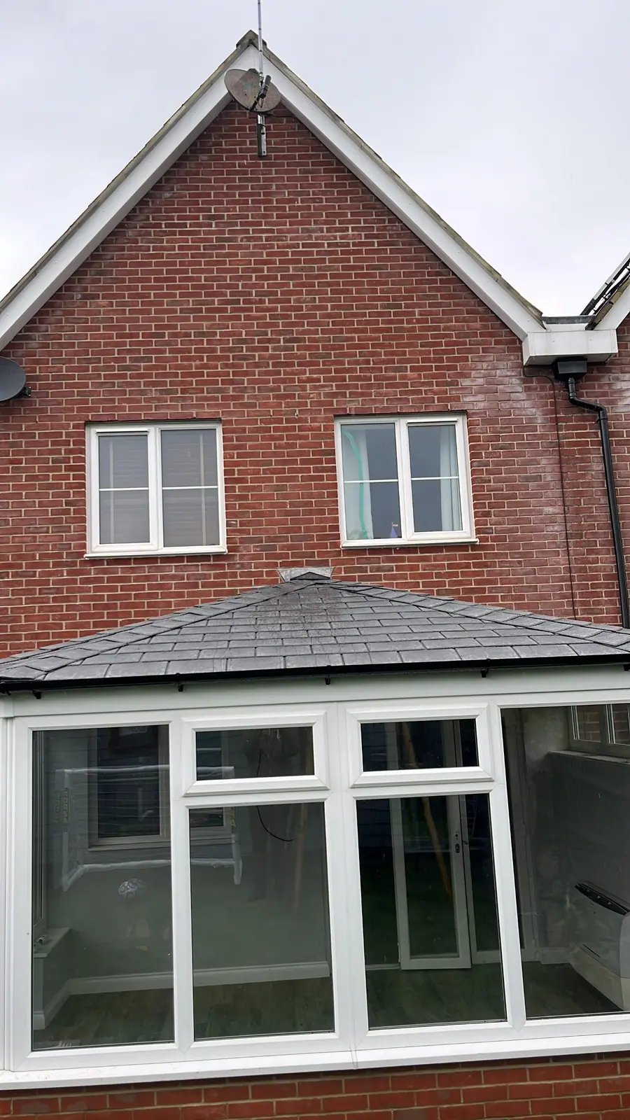 Close view of the completed slate-grey tiled roof
