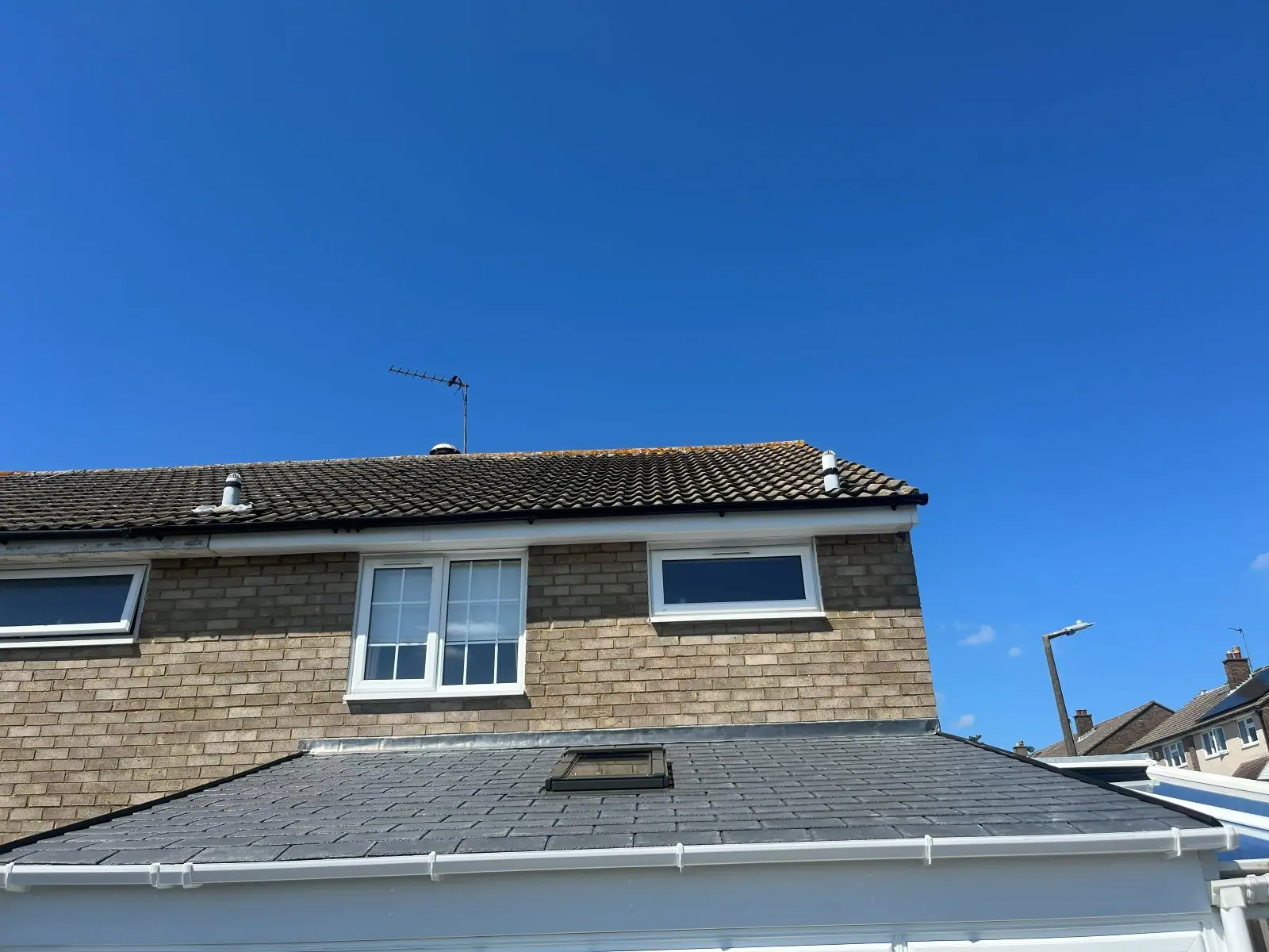 The finished conservatory roof under a clear blue sky