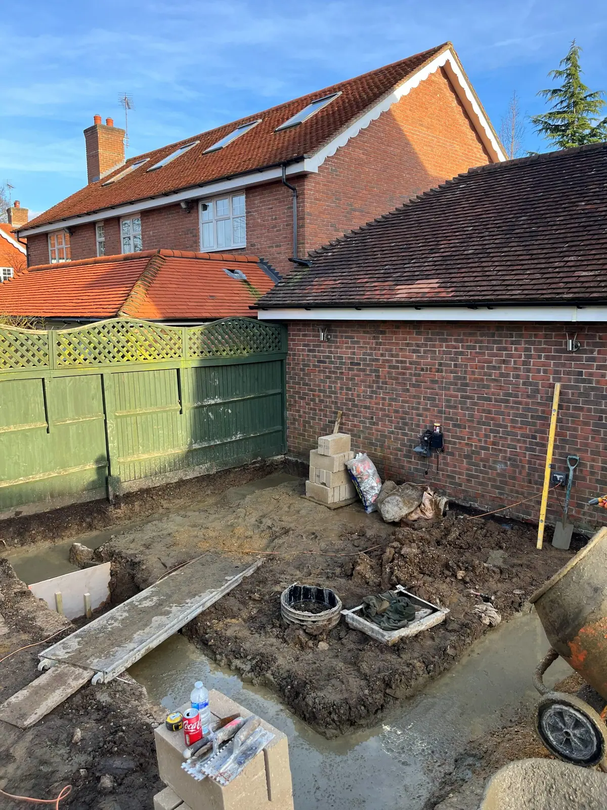 Foundation trenches dug and concreted along the garage wall, ready for the walls