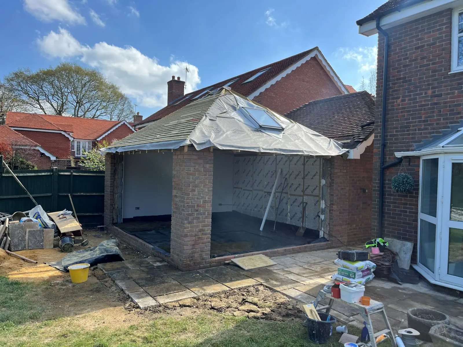 The roof covered in breathable membrane and battens, with the roof window fitted