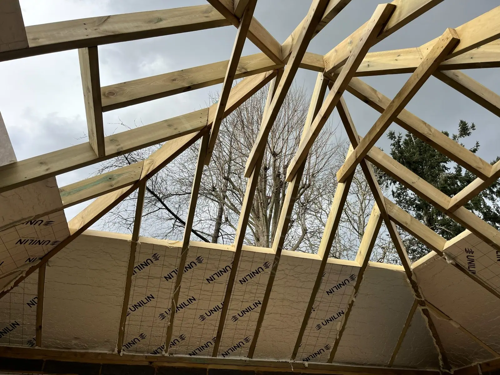 Looking up through the new rafters, with insulation boards fitted between them