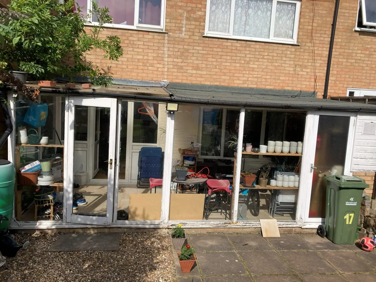 A full-width lean-to conservatory with a translucent roof across the back of the house