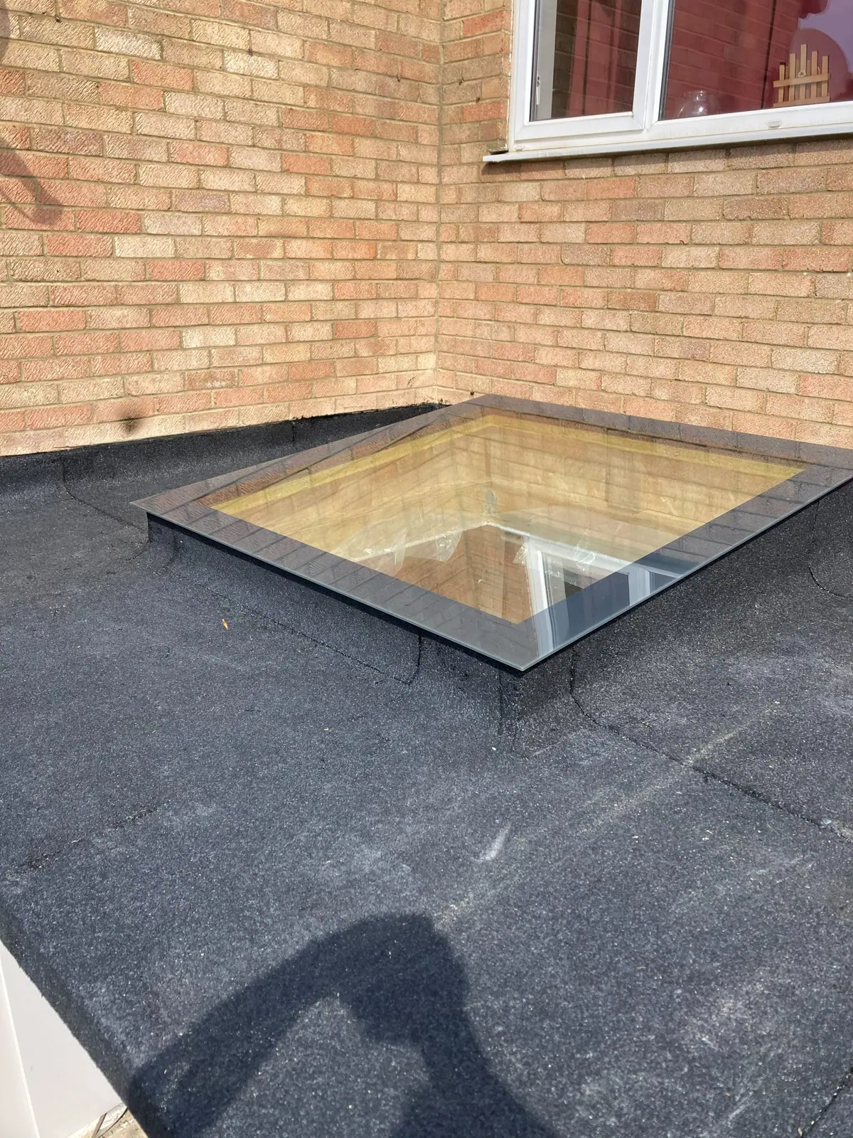 The roof light and membrane seen along the roof towards the house wall