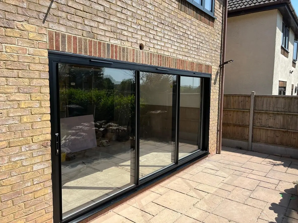 The rear wall opened up and fitted with wide black-framed sliding doors