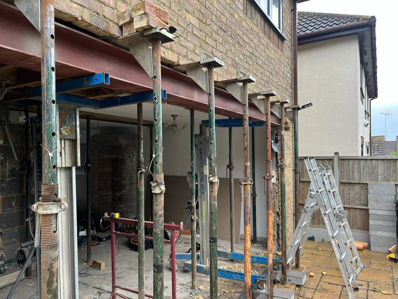 The rear wall held on temporary props while the new steel beams go in above the opening