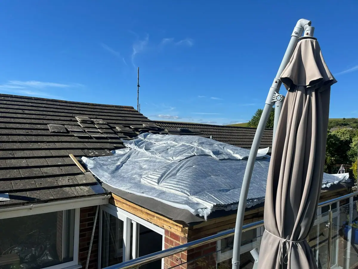 A roof opened up for work and sheeted over to keep the weather out
