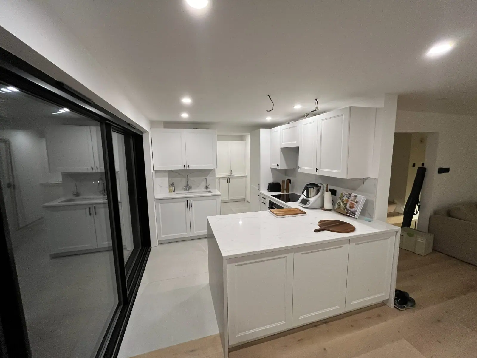 The kitchen and peninsula with the sliding doors to the garden