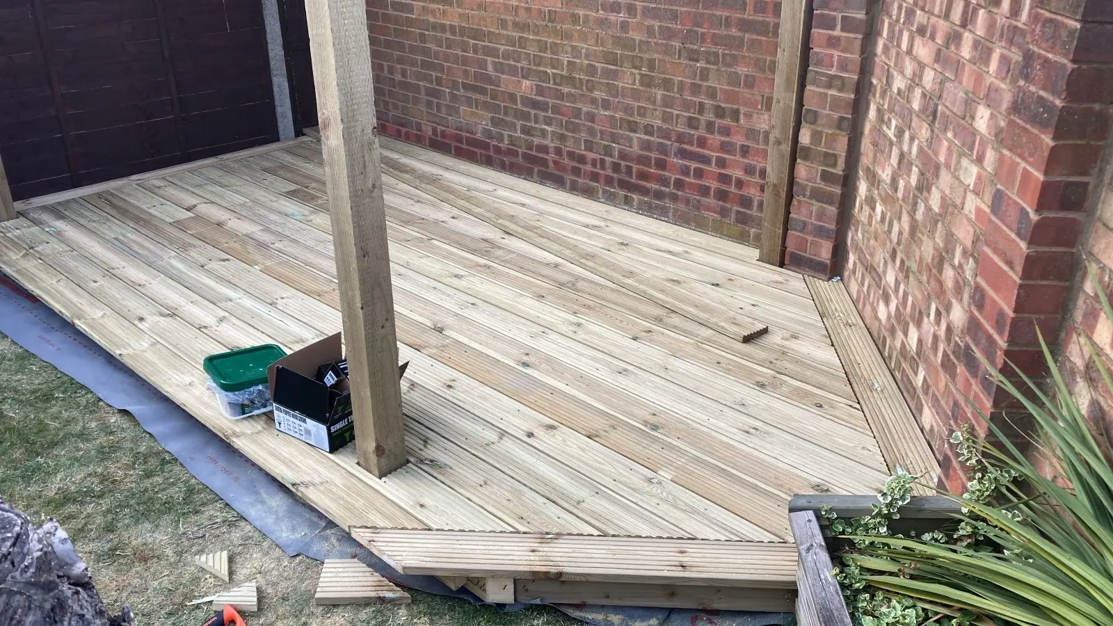 Close view of the deck boards and a pergola post