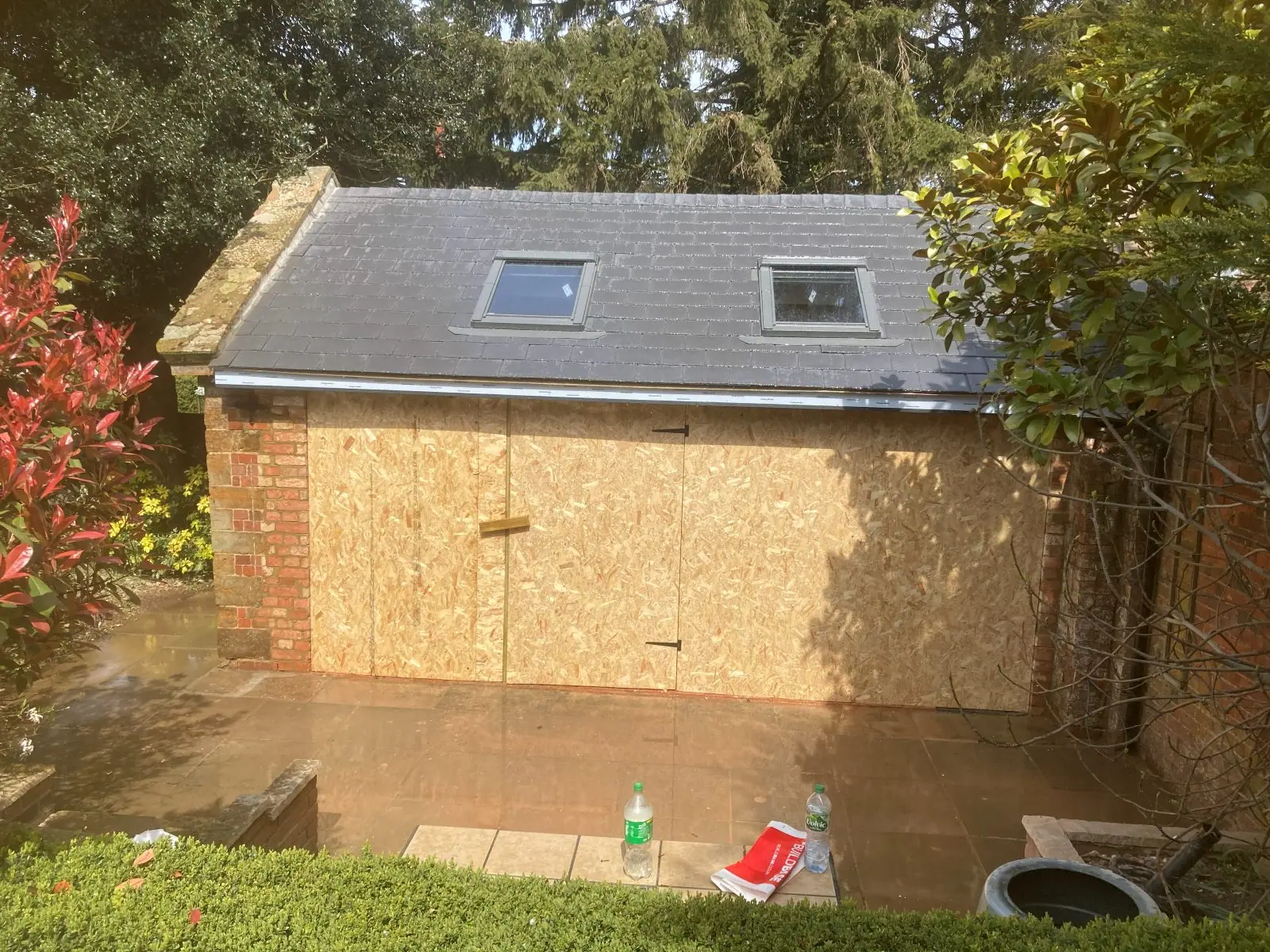 The finished outbuilding roof in slate with two roof windows