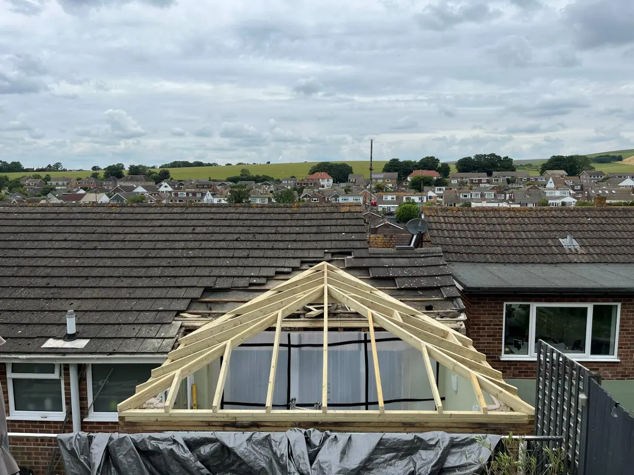 Tired concrete tiled roof on a rear projection before re-roofing